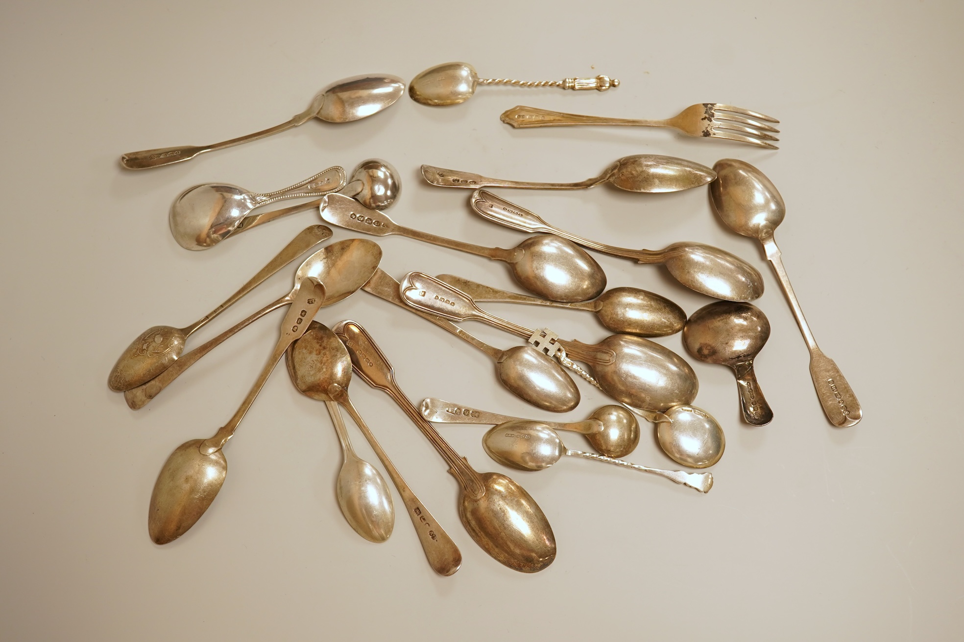A small quantity of 18th century and later assorted silver teaspoons, various patterns, dates and makers, together with a George V silver pastry fork and two George V silver caddy spoons, 10.7oz.